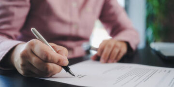 businesswoman signing an official document