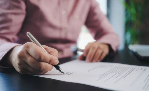 businesswoman signing an official document